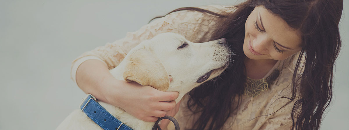 A woman looking at her dog